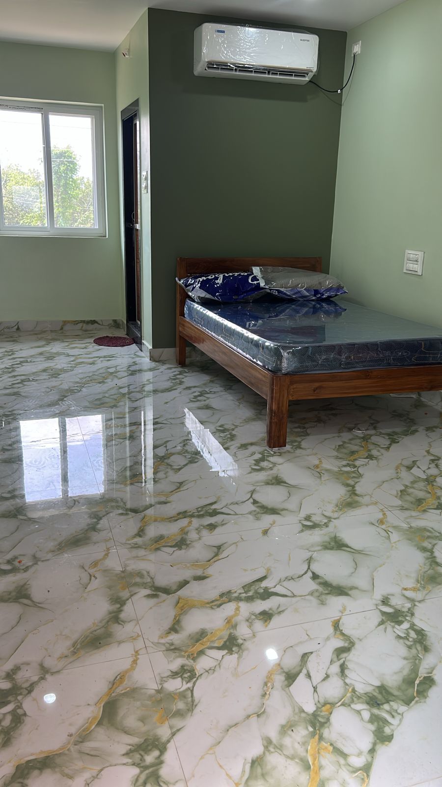Luxury guest room floor detail with wooden bed at Surabhi SJN