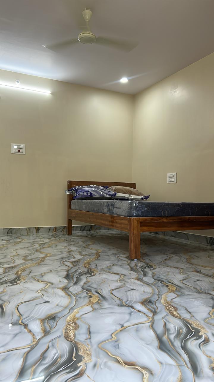 Guest room bed with warm lighting and ceiling fan