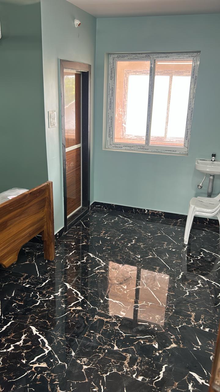 Black marble-style floor room with wooden bed and AC