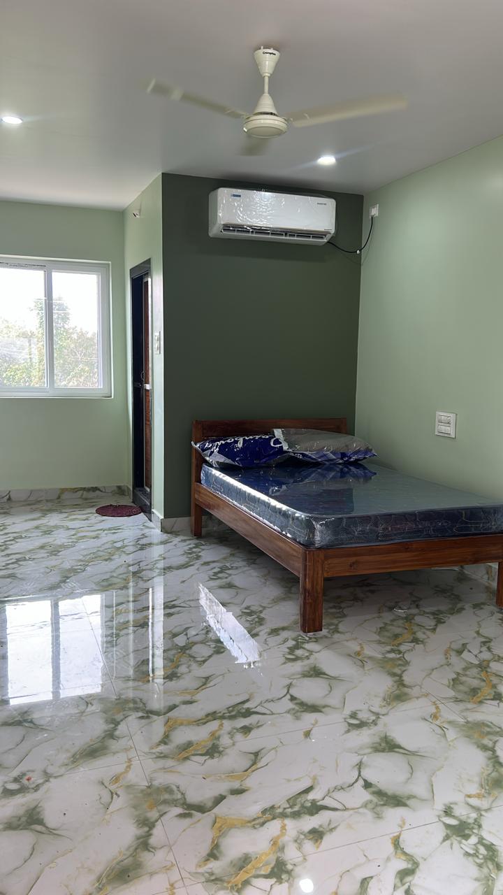 Blue accent room with AC above wooden bed