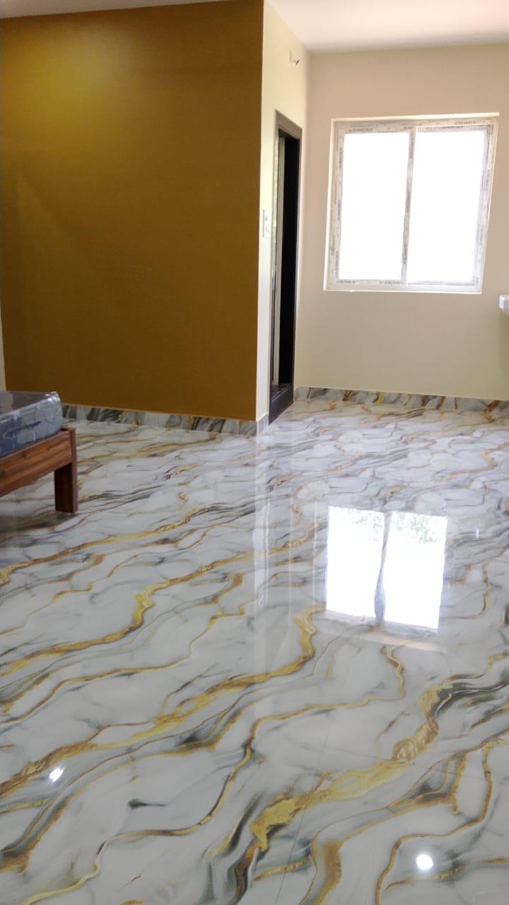 Cream and gold AC guest room with polished marble-style flooring