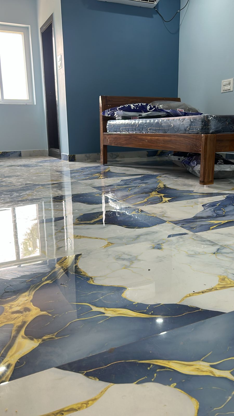 Glossy grey floor AC room with bed and bright window