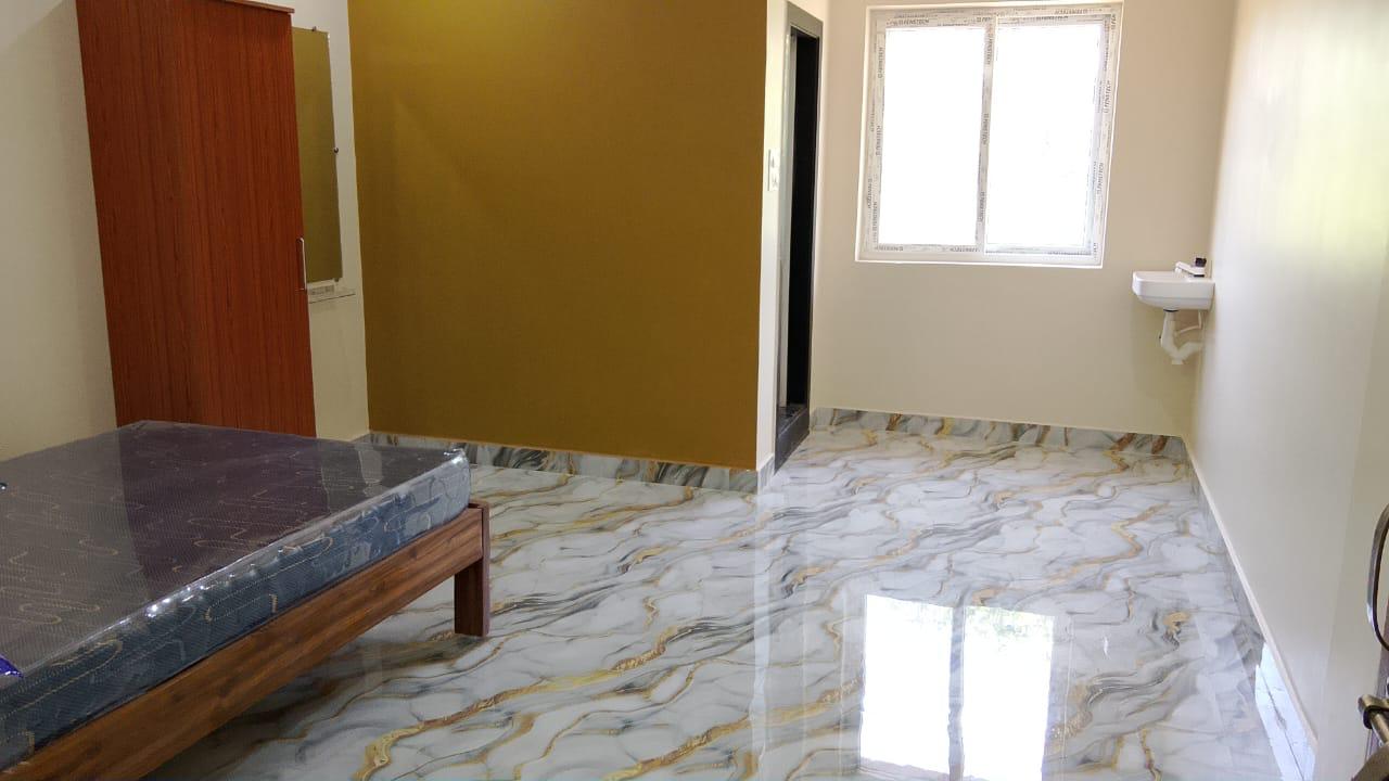 Gold accent luxury AC room with bright window at Surabhi SJN