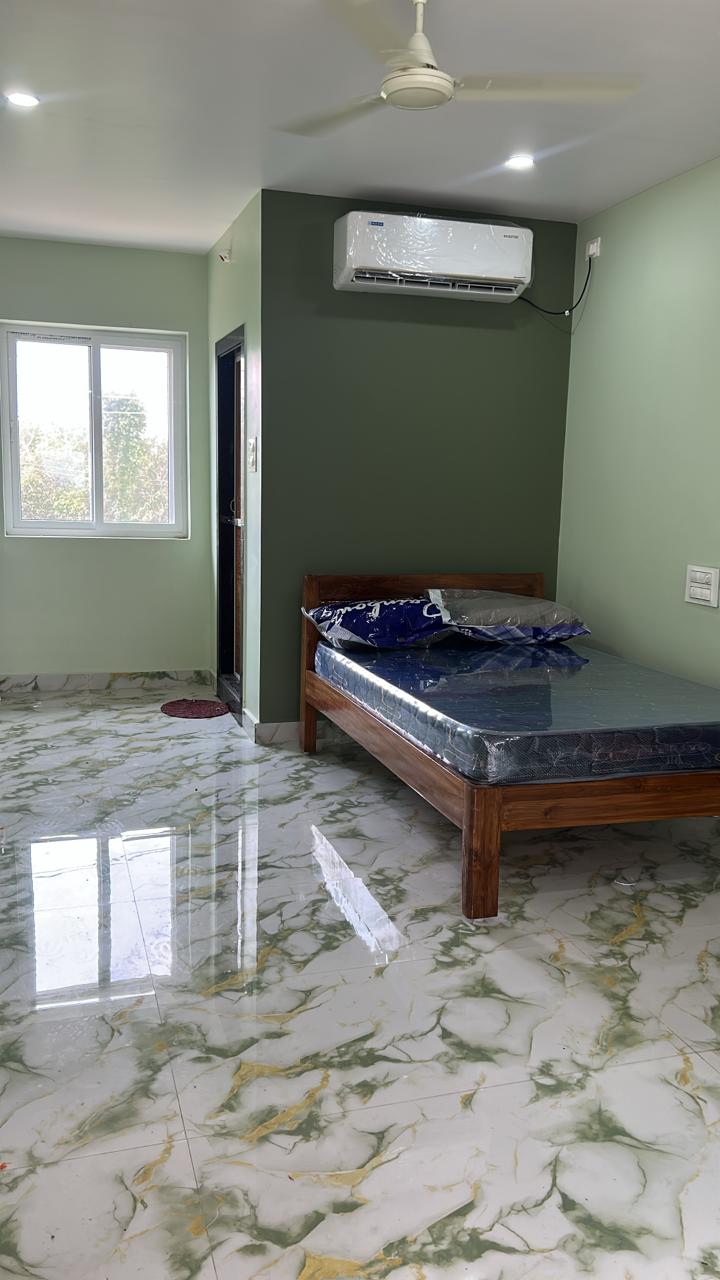 Green accent room with AC and guest bed