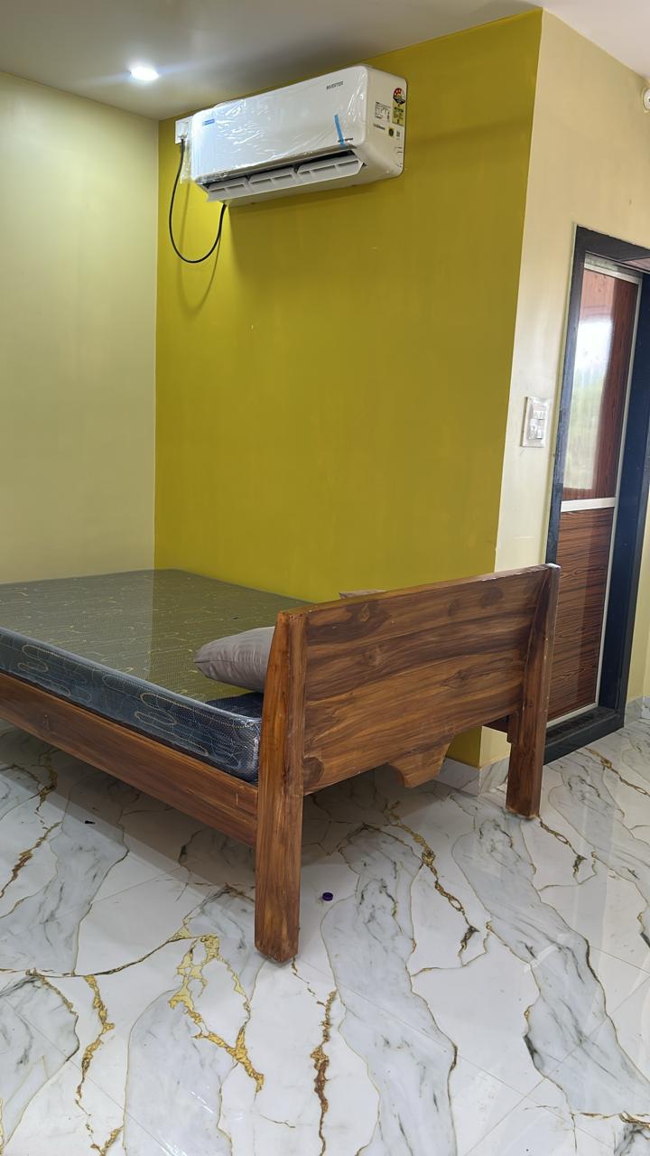 Grey guest room with bright window and glossy floor