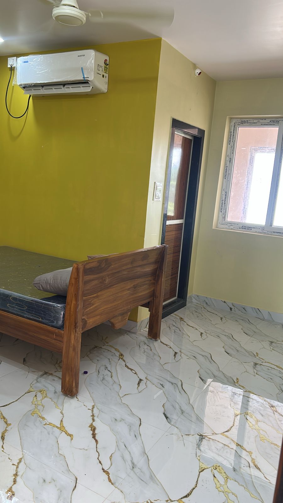 Olive wall AC room with bed and ceiling fan