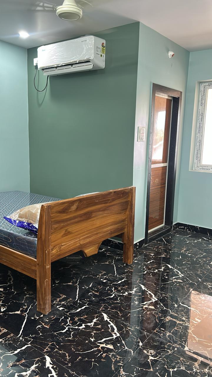 Teal accent guest room with AC and wooden bed