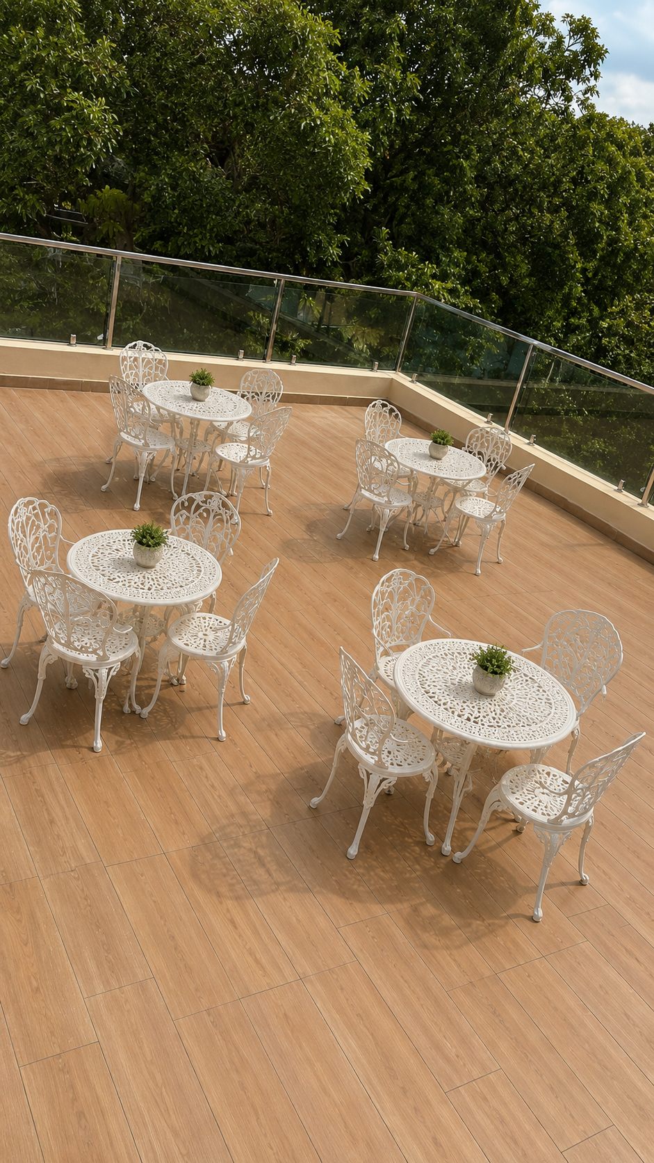 Open-air patio with white tables and chairs for room guests near Rajahmundry